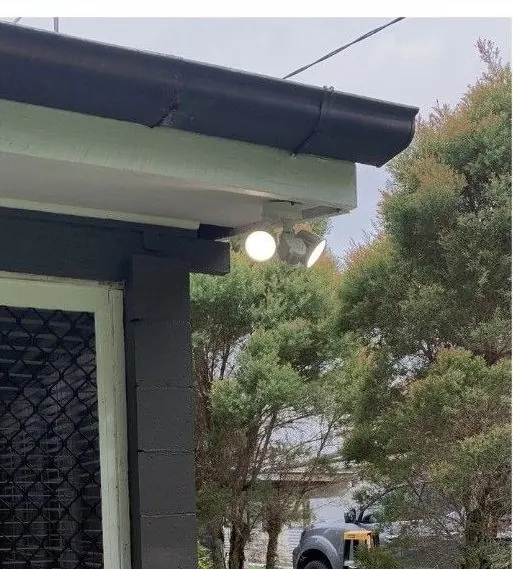 Outdoor light fitted under the eaves of a home