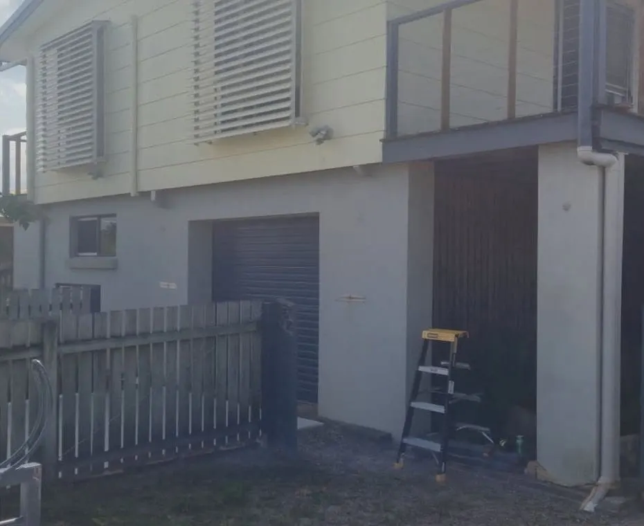 Before: the back of a two-storey home with no outdoor wall lights