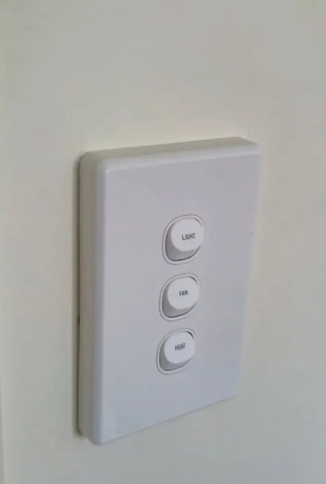 New three-gang light switch on a painted wall
