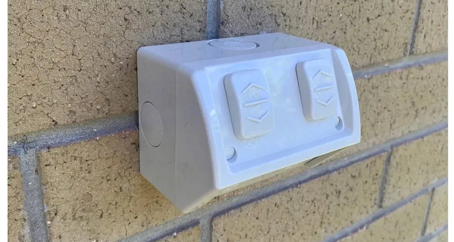 Weatherproof double power point mounted on a brick wall