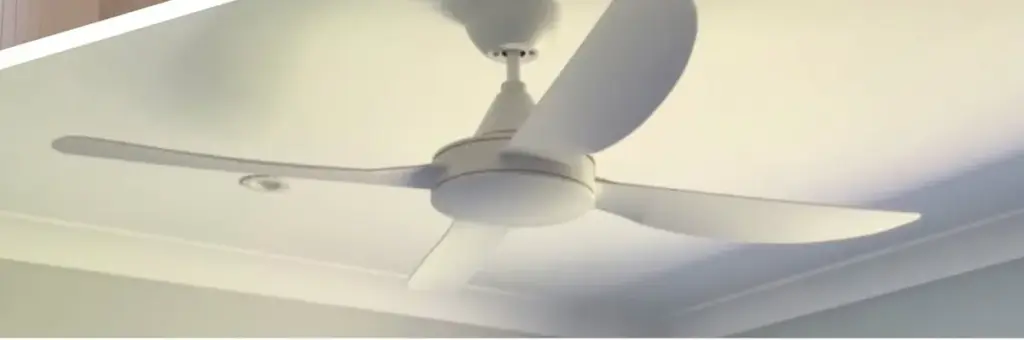 White three-blade ceiling fan installed in a bright room
